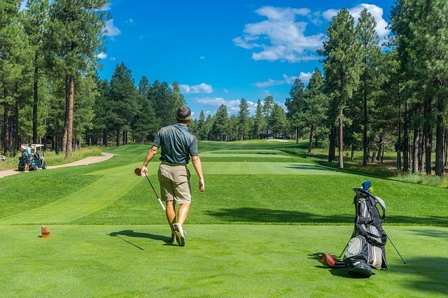 Golfer Hitting  Drive Down A Golf Course